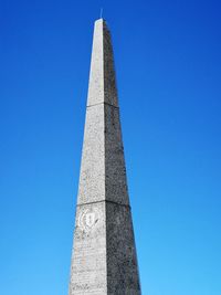 Low angle view of monument against blue sky