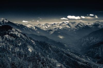 Scenic view of snowcapped mountains against sky at night