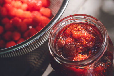 Making homemade jam from picked wild strawberries