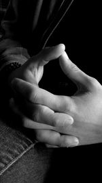 Close-up of father holding baby hand