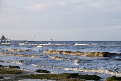 Scenic view of sea and pier against sky