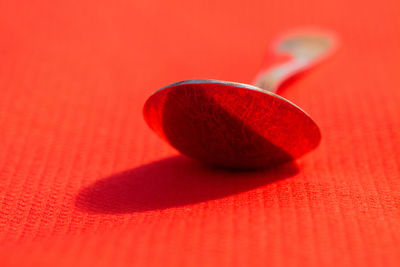 Close-up of spoon on orange table
