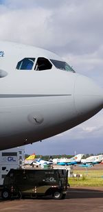 Airplane on airport runway against sky