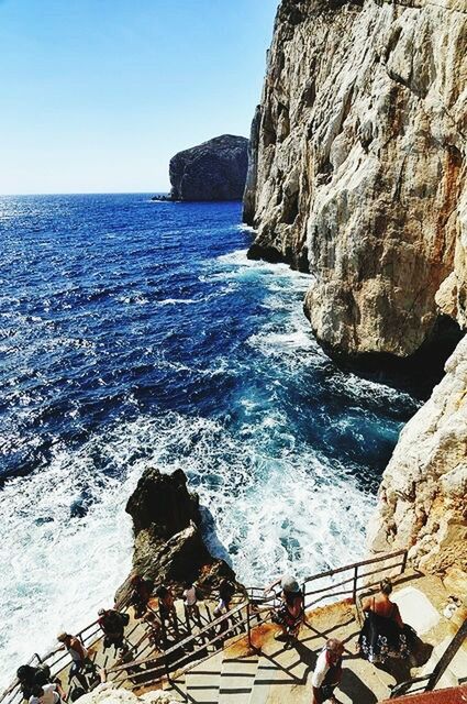 water, sea, rock formation, horizon over water, rock - object, scenics, beauty in nature, nature, tranquil scene, cliff, tranquility, nautical vessel, high angle view, blue, rock, idyllic, day, clear sky, rippled, wave