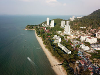 High angle view of sea and buildings against sky