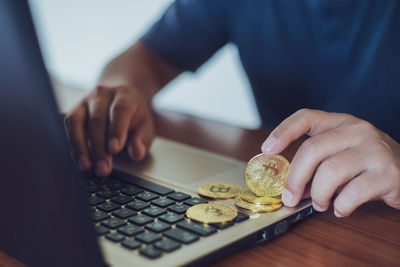 Close-up of hand holding coins