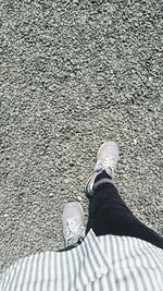 Low section of woman standing on tiled floor