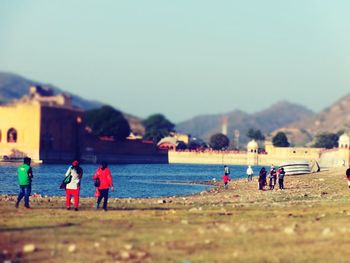 People on beach against sky