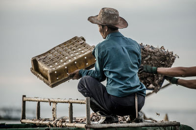 Worker holding fish basket