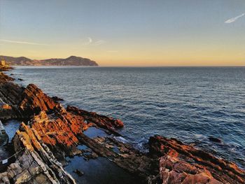 Scenic view of sea against sky at sunset