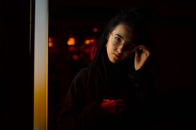 Young woman looking away at night