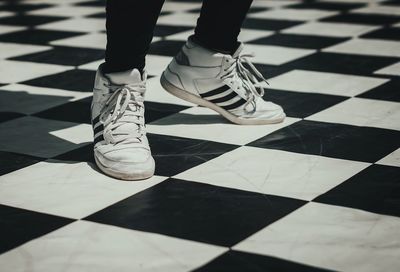 Low section of person on tiled floor