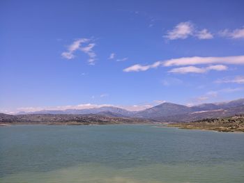 Scenic view of mountains against blue sky