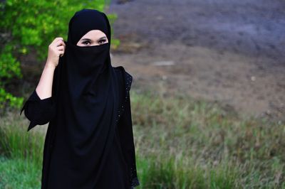 Person wearing mask standing on field