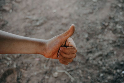Close-up of man hand gesturing outdoors