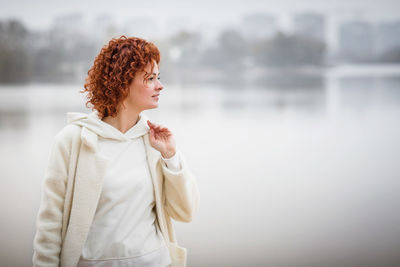 Happy redhair woman in white clothes