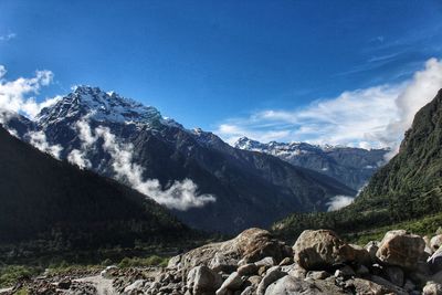 Scenic view of snowcapped mountains against blue sky