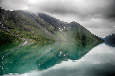 Scenic view of lake and mountains against sky