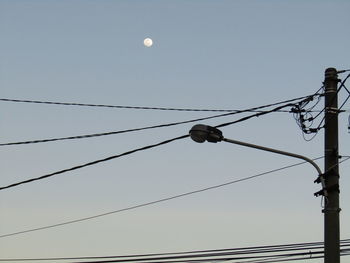 Low angle view of street light against clear sky at dusk