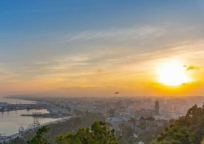 High angle view of buildings against sky during sunset