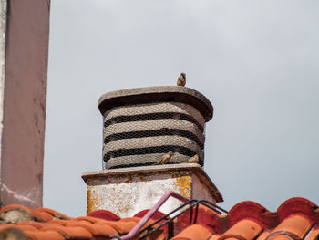 Low angle view of machine part against sky