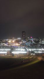 Illuminated cityscape against sky at night