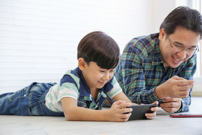 Friends looking away while using mobile phone