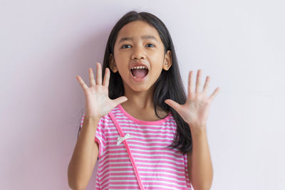 Portrait of a smiling girl over white background