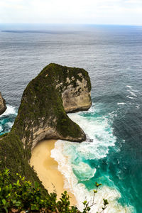 High angle view of rocks on sea shore