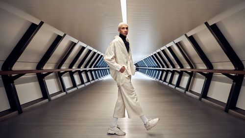 Portrait of man standing against railing