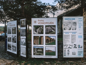 Information sign on field against trees