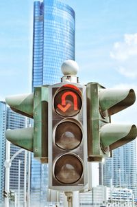 Low angle view of no u turn traffic signal against sky