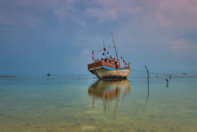 Boat in sea against sky