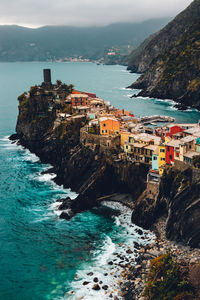 Scenic view of sea by buildings against sky