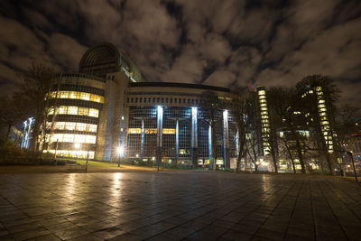 Illuminated buildings against sky at night