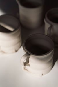 Raw unfinished ceramic cups on the table