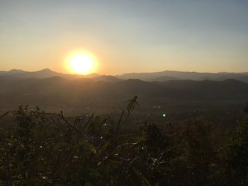 Scenic view of field against sky during sunset