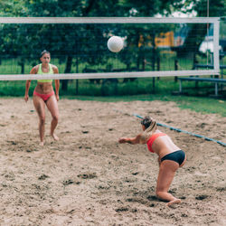 Young women playing beach volleyball