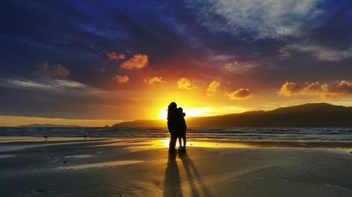 People on beach at sunset