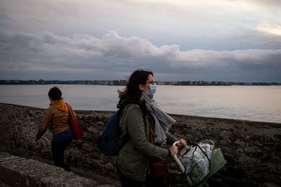 People on beach against sky