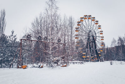 Outdoor play equipment in city against sky during winter