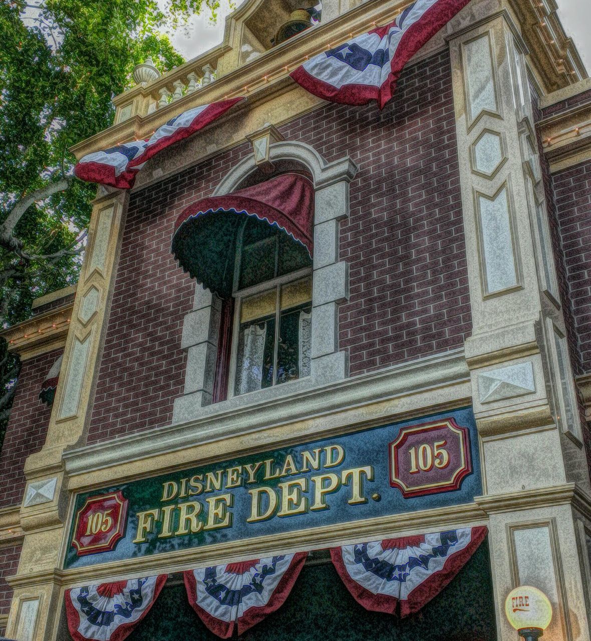 text, architecture, building exterior, low angle view, built structure, western script, communication, non-western script, day, art and craft, window, outdoors, building, no people, art, capital letter, ornate, information, sign, tree