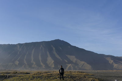 Full length of man standing on land against sky mount bromo