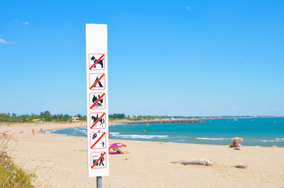 Scenic view of beach against clear blue sky