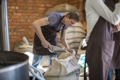 Side view of man preparing food