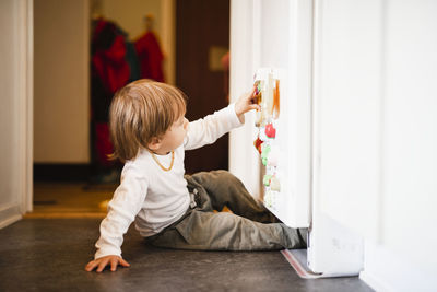 Boy playing with fridge magnets