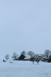 Scenic view of snow covered field against clear sky