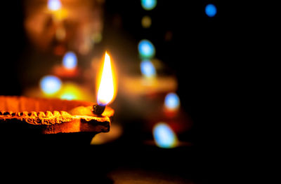 Close-up of lit candles in the dark