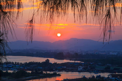 Scenic view of lake against orange sky