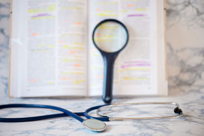 High angle view of magnifying glass on table